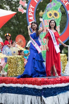 Washington, D.C., USA - July 4, 2018, The National Independence Day Parade, Taiwanese beauty queens on a float, going down constitution avenue during the parade