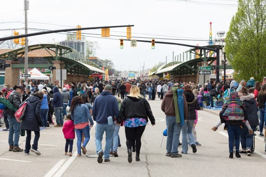 Holland, Michigan, USA - May 12, 2018 View of the street full of people going to the carnival after the Muziek Parade, during the Tulip Time Festival