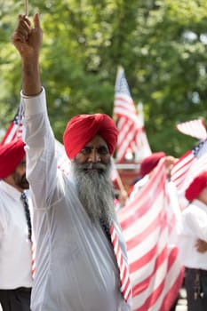 Washington, D.C., USA - July 4, 2018, The National Independence Day Parade, The Sikhs of America, waving american flags, going down constitution avenue during the parade