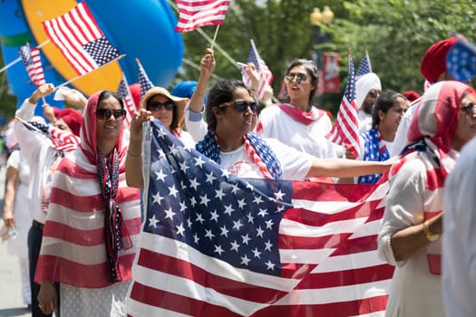 Washington, D.C., USA - July 4, 2018, The National Independence Day Parade, The Sikhs of America, waving american flags, going down constitution avenue during the parade
