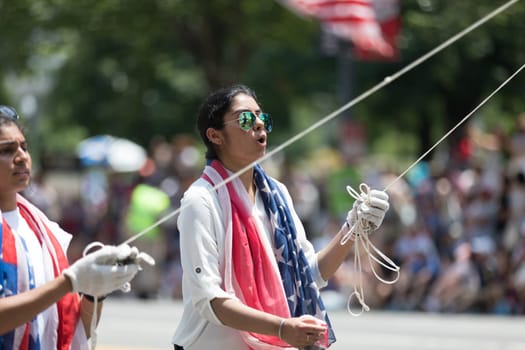 Washington, D.C., USA - July 4, 2018, The National Independence Day Parade, The Sikhs of America, waving american flags, going down constitution avenue during the parade