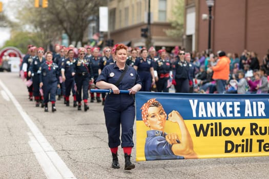 Holland, Michigan, USA - May 12, 2018 Women dress up as Rosie sing and dance at the Muziek Parade, during the Tulip Time Festival