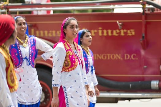 Washington, D.C., USA - July 4, 2018, The National Independence Day Parade, Indian women, dancers, wearing traditional clothing, going down constitution avenue