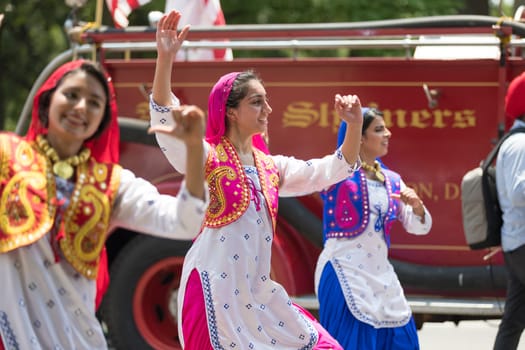 Washington, D.C., USA - July 4, 2018, The National Independence Day Parade, Indian women, dancers, wearing traditional clothing, going down constitution avenue