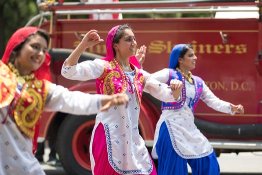 Washington, D.C., USA - July 4, 2018, The National Independence Day Parade, Indian women, dancers, wearing traditional clothing, going down constitution avenue