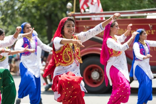 Washington, D.C., USA - July 4, 2018, The National Independence Day Parade, Indian women, dancers, wearing traditional clothing, going down constitution avenue