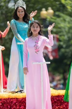 Washington, D.C., USA - July 4, 2018, The National Independence Day Parade, Vietnamese American women wearing traditional dresses, going down constitution avenue