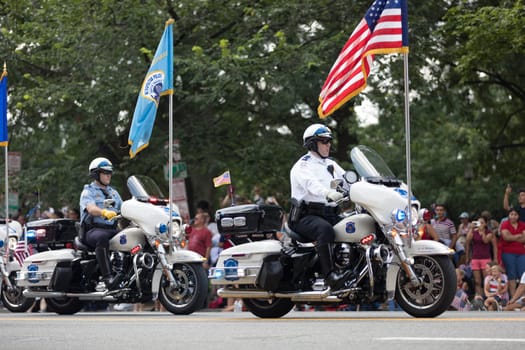 Washington, D.C., USA - July 4, 2018, Police officer on motorcycles carry the american flag at the National Independence Day Parade