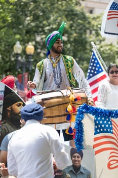 Washington, D.C., USA - July 4, 2018, The National Independence Day Parade, The Sikhs of America, waving american flags, going down constitution avenue during the parade
