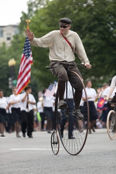 Washington, D.C., USA - July 4, 2018, The National Independence Day Parade, People riding antique bicycles down constitution avenue during the parade