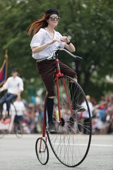 Washington, D.C., USA - July 4, 2018, The National Independence Day Parade, People riding antique bicycles down constitution avenue during the parade