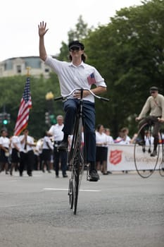 Washington, D.C., USA - July 4, 2018, The National Independence Day Parade, People riding antique bicycles down constitution avenue during the parade