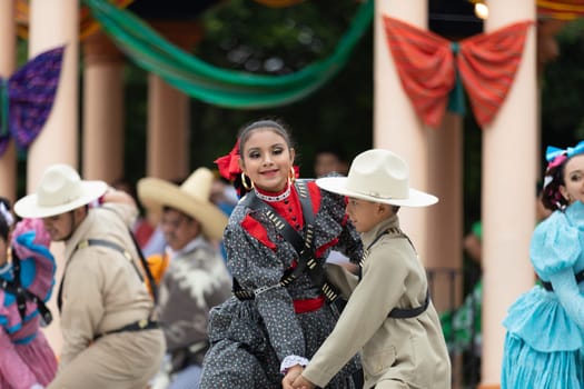 Matamoros, Tamaulipas, Mexico - November 20, 2018: The November 20 Festival, Young men and women wearing traditional mexican clothing, perform traditional mexican dances at the Plaza Miguel Hidalgo.