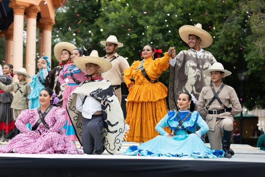 Matamoros, Tamaulipas, Mexico - November 20, 2018: The November 20 Festival, Young men and women wearing traditional mexican clothing, pose for the camera at the Plaza Miguel Hidalgo.