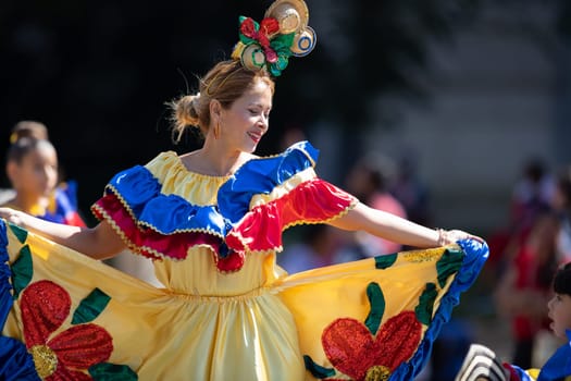 Washington, D.C., USA - September 29, 2018: The Fiesta DC Parade, Colombian woman wearing traditional colombian clothing dancing