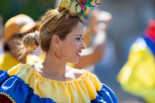 Washington, D.C., USA - September 29, 2018: The Fiesta DC Parade, Colombian woman wearing traditional colombian clothing dancing
