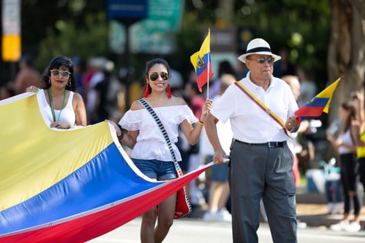Washington, D.C., USA - September 29, 2018: The Fiesta DC Parade, Men and women holding a giant Ecuadorian flag