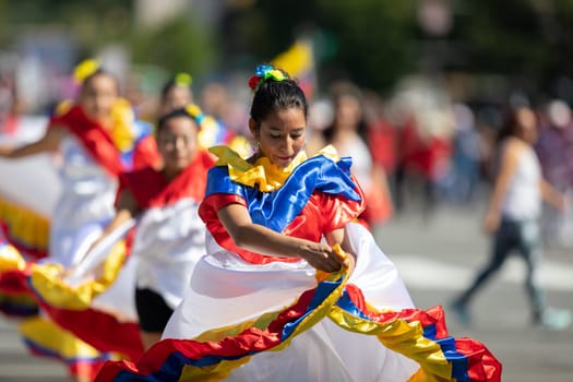 Washington, D.C., USA - September 29, 2018: The Fiesta DC Parade, Young women wearing traditional ecuadorian clothing dancing