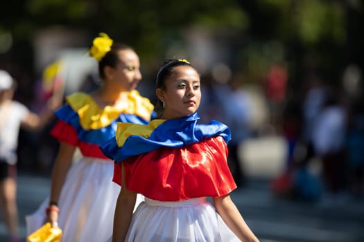 Washington, D.C., USA - September 29, 2018: The Fiesta DC Parade, Young women wearing traditional ecuadorian clothing dancing