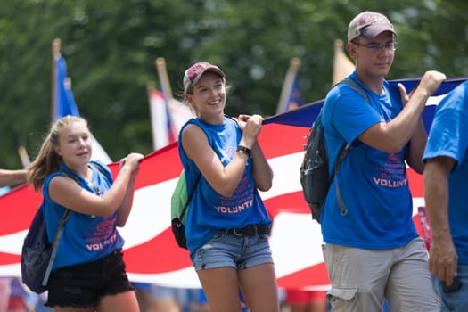 Washington, D.C., USA - July 4, 2018, The National Independence Day Parade, The National Independence Day Volunteers carrying flags down constitution avenue