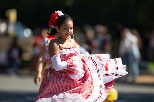 Washington, D.C., USA - September 29, 2018: The Fiesta DC Parade, Colombian girl wearing traditional clothing dancing