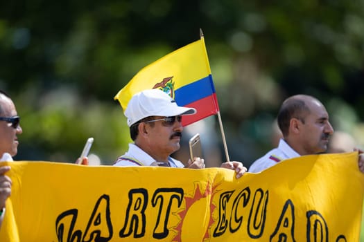 Washington, D.C., USA - September 29, 2018: The Fiesta DC Parade, Man holding the flag form Ecuador, walking down the street