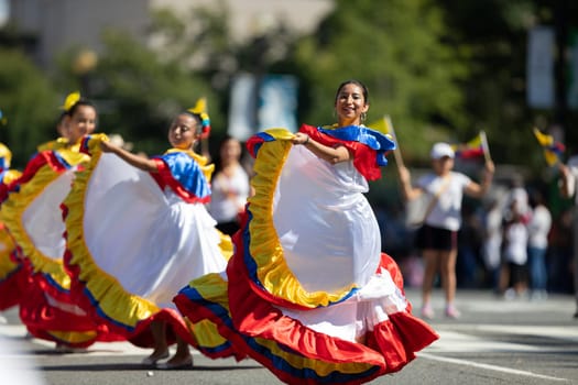 Washington, D.C., USA - September 29, 2018: The Fiesta DC Parade, Young women wearing traditional ecuadorian clothing dancing