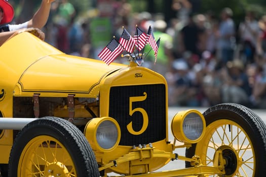 Washington, D.C., USA - July 4, 2018, The National Independence Day Parade, The Ford Model T Speedster race car, carrying american flags, going down constitution avenue