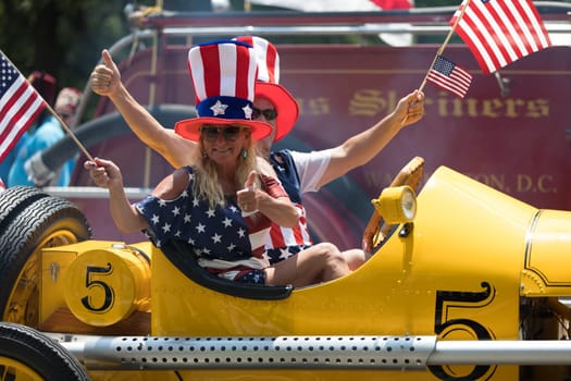 Washington, D.C., USA - July 4, 2018, The National Independence Day Parade, The Ford Model T Speedster race car, carrying american flags, going down constitution avenue