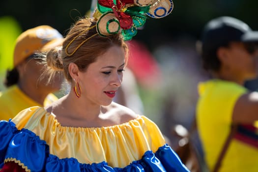 Washington, D.C., USA - September 29, 2018: The Fiesta DC Parade, Colombian woman wearing traditional colombian clothing dancing