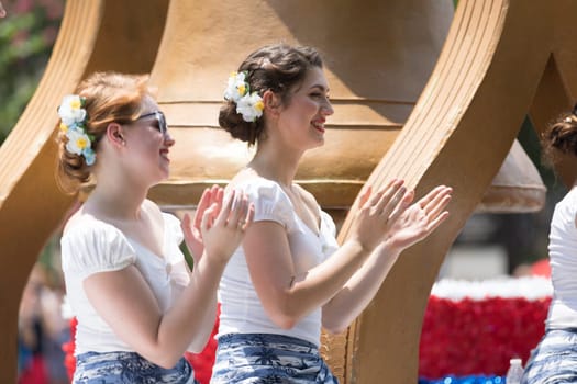 Washington, D.C., USA - July 4, 2018, The National Independence Day Parade, Young women wearing retro outfits, on a float, going down constitution avenue