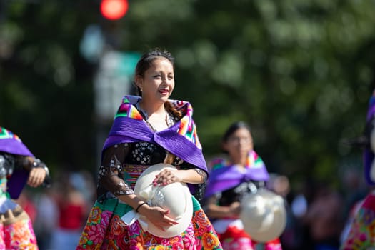 Washington, D.C., USA - September 29, 2018: The Fiesta DC Parade, Peruvian women wearing traditional clothing danicng during the parade