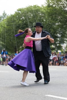 Washington, D.C., USA - July 4, 2018, The National Independence Day Parade, The Gottaswing Dancers, with outfits from the 60s, going down constitution avenue