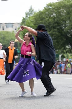 Washington, D.C., USA - July 4, 2018, The National Independence Day Parade, The Gottaswing Dancers, with outfits from the 60s, going down constitution avenue