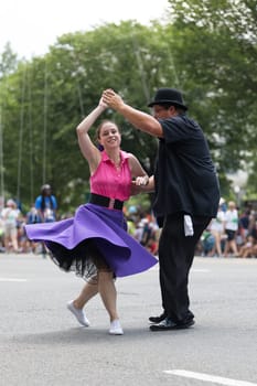 Washington, D.C., USA - July 4, 2018, The National Independence Day Parade, The Gottaswing Dancers, with outfits from the 60s, going down constitution avenue
