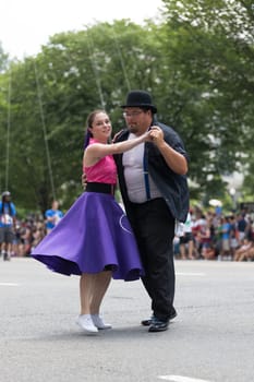 Washington, D.C., USA - July 4, 2018, The National Independence Day Parade, The Gottaswing Dancers, with outfits from the 60s, going down constitution avenue