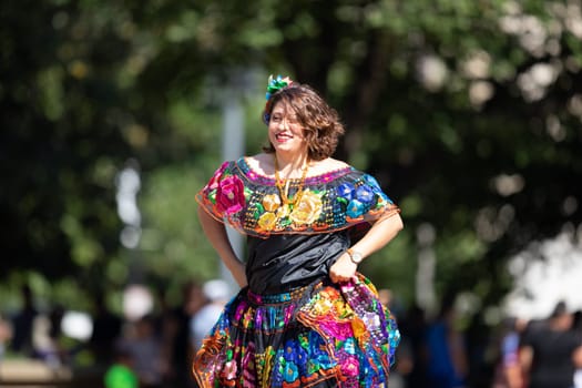 Washington, D.C., USA - September 29, 2018: The Fiesta DC Parade, Woman wearing traditional clothing from Mexico dancing