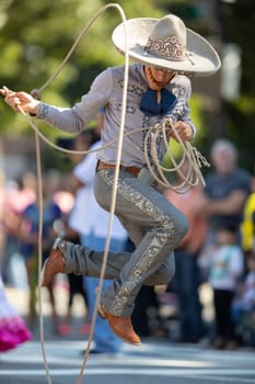 Washington, D.C., USA - September 29, 2018: The Fiesta DC Parade, Man wearing traditional clothing from Mexico handling a lasso