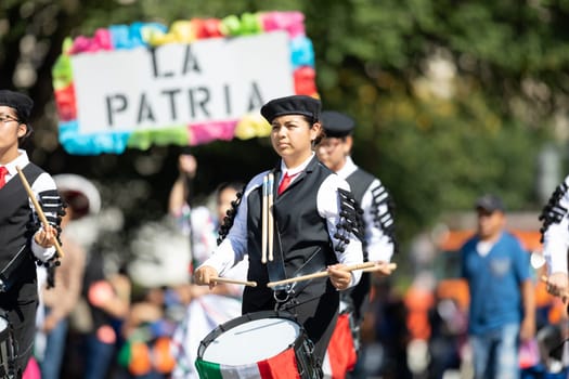 Washington, D.C., USA - September 29, 2018: The Fiesta DC Parade, Marching band playing the drums with mexican flags and a banner that say la Patria