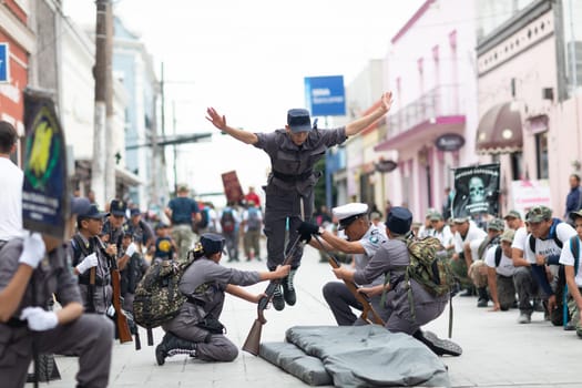 Matamoros, Tamaulipas, Mexico - November 20, 2018: The November 20 Parade, Members of the Pentathlon wearing military uniforms jumping over rifles and bayonnet