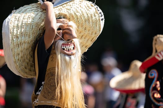 Washington, D.C., USA - September 29, 2018: The Fiesta DC Parade, Mexican man wearing an abstract face mask and a big sombrero