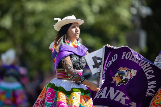 Washington, D.C., USA - September 29, 2018: The Fiesta DC Parade, Peruvian women wearing traditional clothing danicng during the parade
