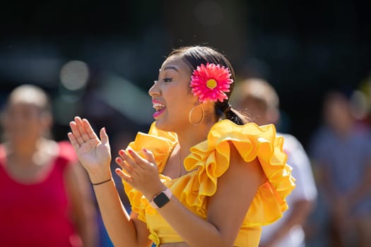 Washington, D.C., USA - September 29, 2018: The Fiesta DC Parade, peruvian woman wearing traditional clothing danicng during the parade