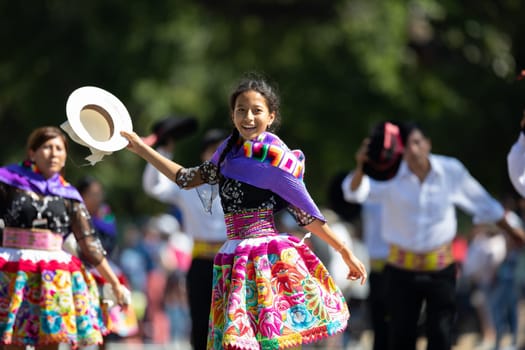 Washington, D.C., USA - September 29, 2018: The Fiesta DC Parade, Peruvian women wearing traditional clothing danicng during the parade