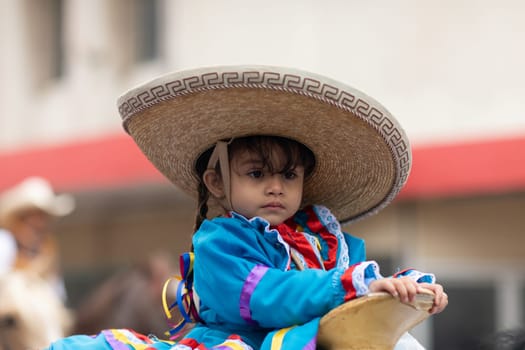 Matamoros, Tamaulipas, Mexico - November 20, 2018: The November 20 Parade, Child wearing traditional mexican clothing riding horses during the parade