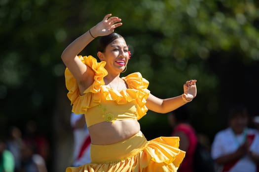 Washington, D.C., USA - September 29, 2018: The Fiesta DC Parade, peruvian woman wearing traditional clothing danicng during the parade