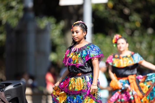 Washington, D.C., USA - September 29, 2018: The Fiesta DC Parade, Woman wearing traditional clothing from Mexico dancing