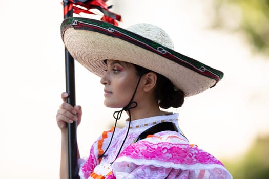 Washington, D.C., USA - September 29, 2018: The Fiesta DC Parade, Woman wearing traditional clothing from Mexico carrying a banner