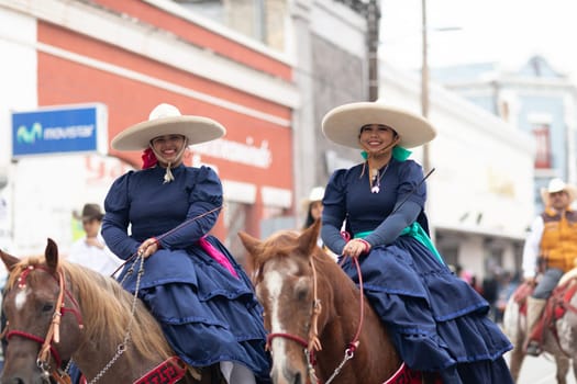 Matamoros, Tamaulipas, Mexico - November 20, 2018: The November 20 Parade, women wearing traditional mexican clothing riding horses during the parade