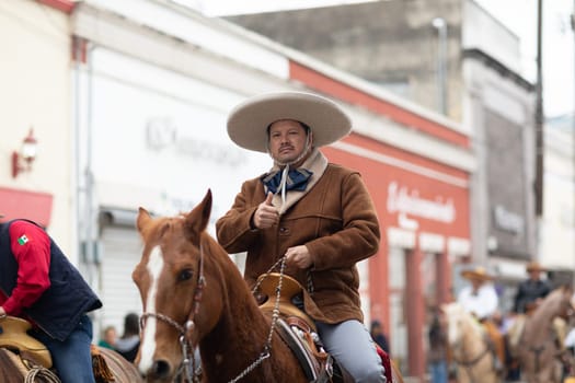 Matamoros, Tamaulipas, Mexico - November 20, 2018: The November 20 Parade, Men wearing traditional mexican clothing riding horses during the parade